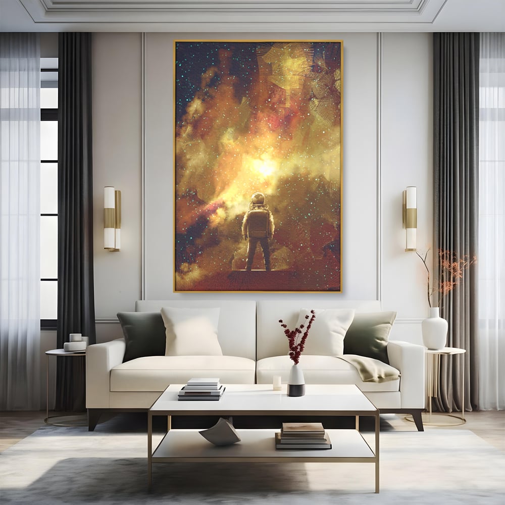 Tablou canvas cu ilustratie cu astronaut privind stelele, in rama de aluminiu auriu, pe perete intr-un living